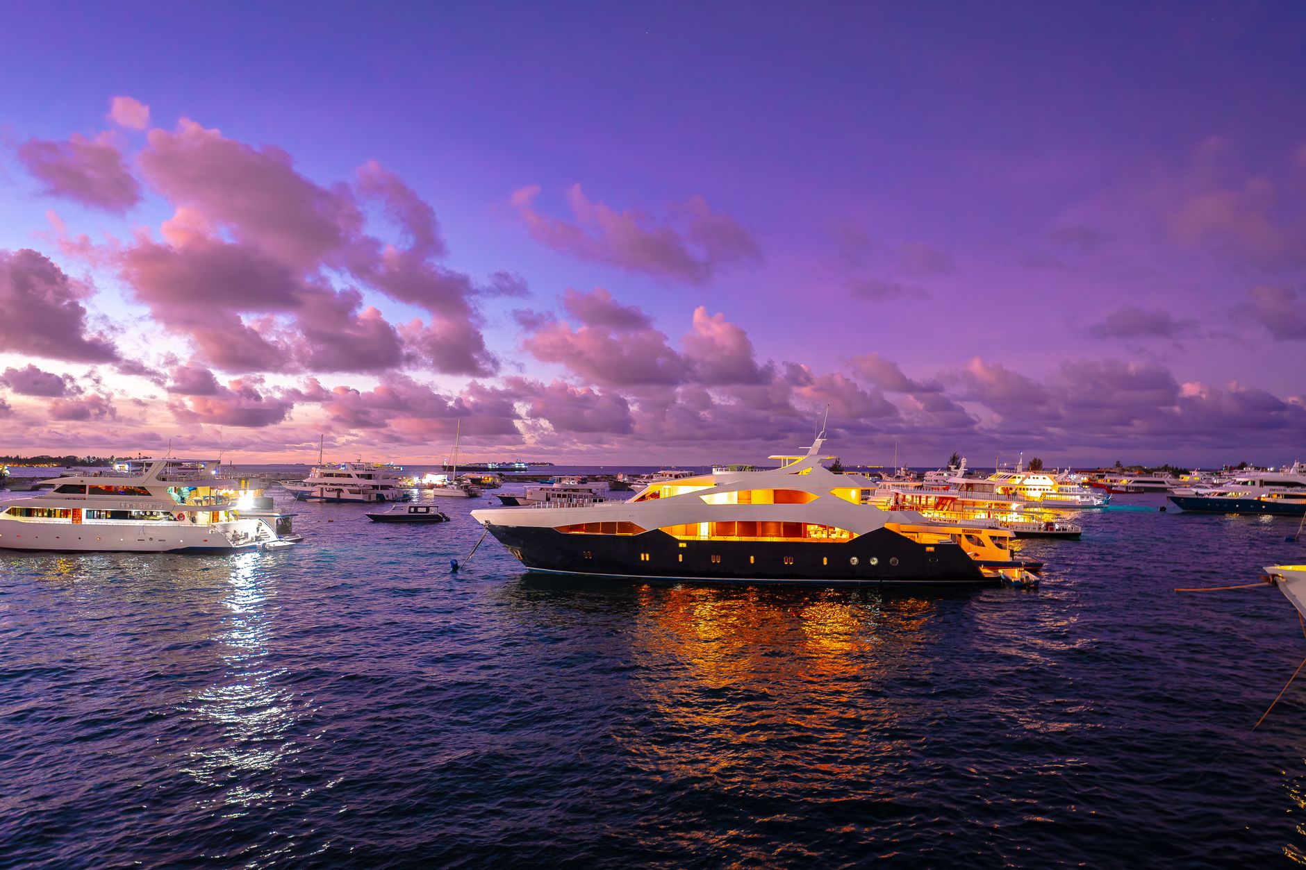 luxurious yachts at twilight in maldives